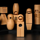 The Teenage Engineering wooden choir dolls photographed on a black background.